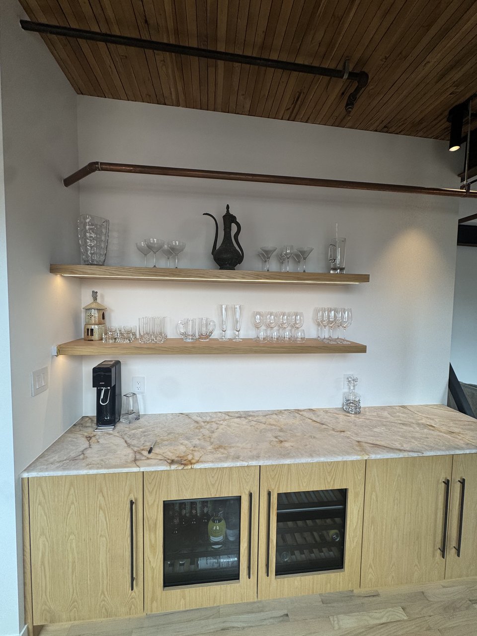 Floating oak shelves over a stone bar counter, Powell loft renovation, Vancouver BC